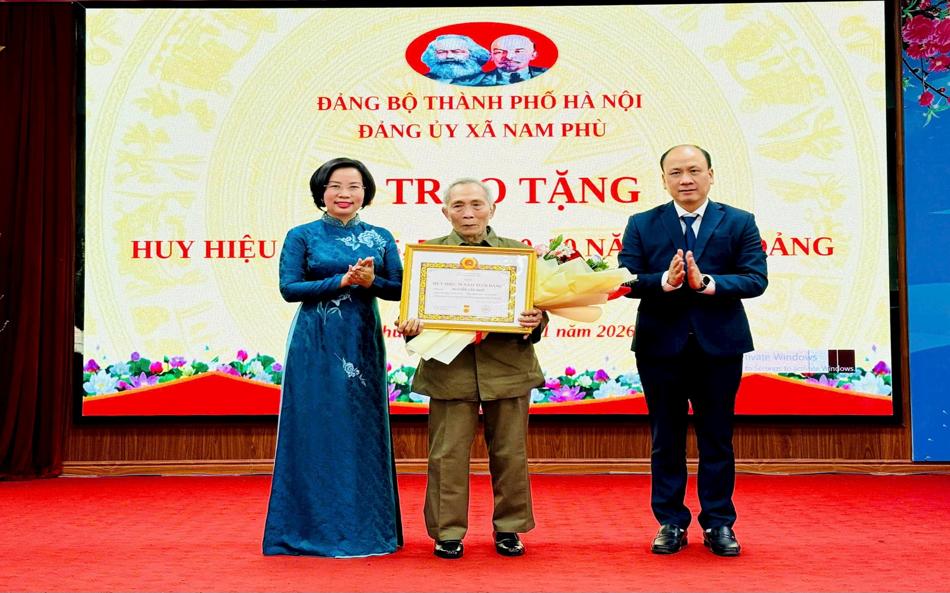 Chủ tịch Ủy ban MTTQ Việt Nam thành phố Hà Nội Bùi Huyền Mai và lãnh đạo xã Nam Phù trao Huy hiệu Đảng tặng các đảng viên. 
