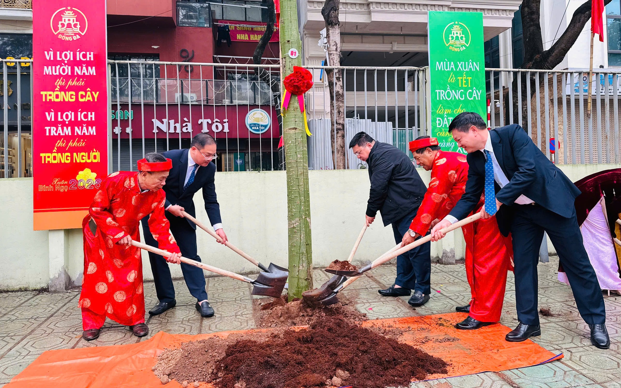 Lãnh đạo phường Đống Đa cùng người cao tuổi trồng cây tại khuôn viên Trường THCS Thái Thịnh.